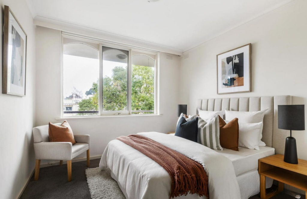 hawthorn main bedroom stage, charcoal, orange, grey colours. Centre window bringing nature light in.