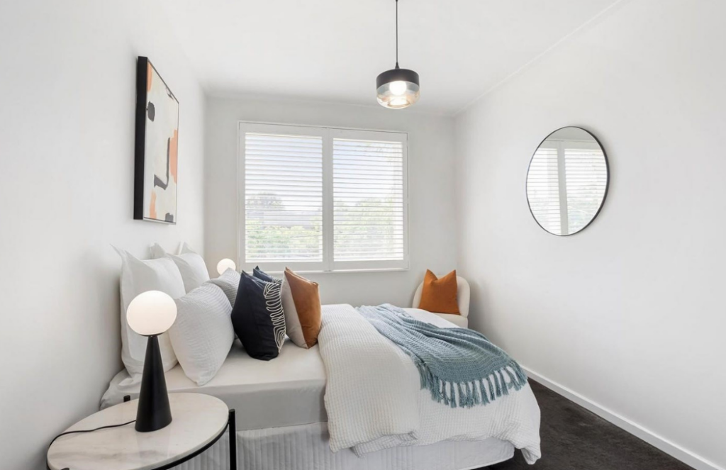 second bedroom staging, modern styled bedroom with warm colours and mixed turquoise. 3122