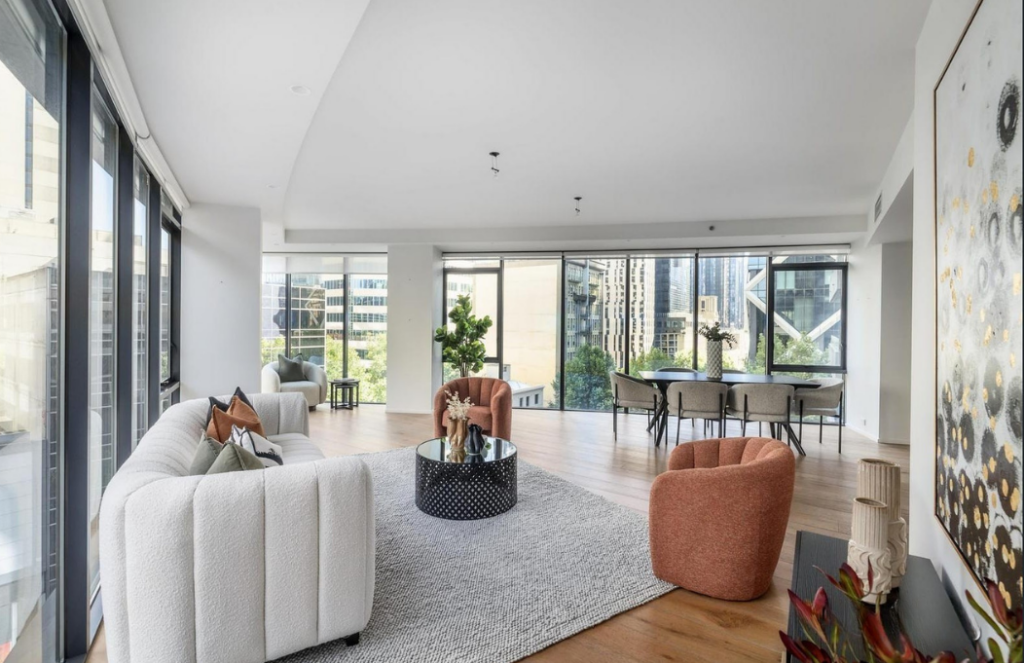 beach house property styled dining room, 8 seater dining timber dining table, modern grey chairs with natural lighting.