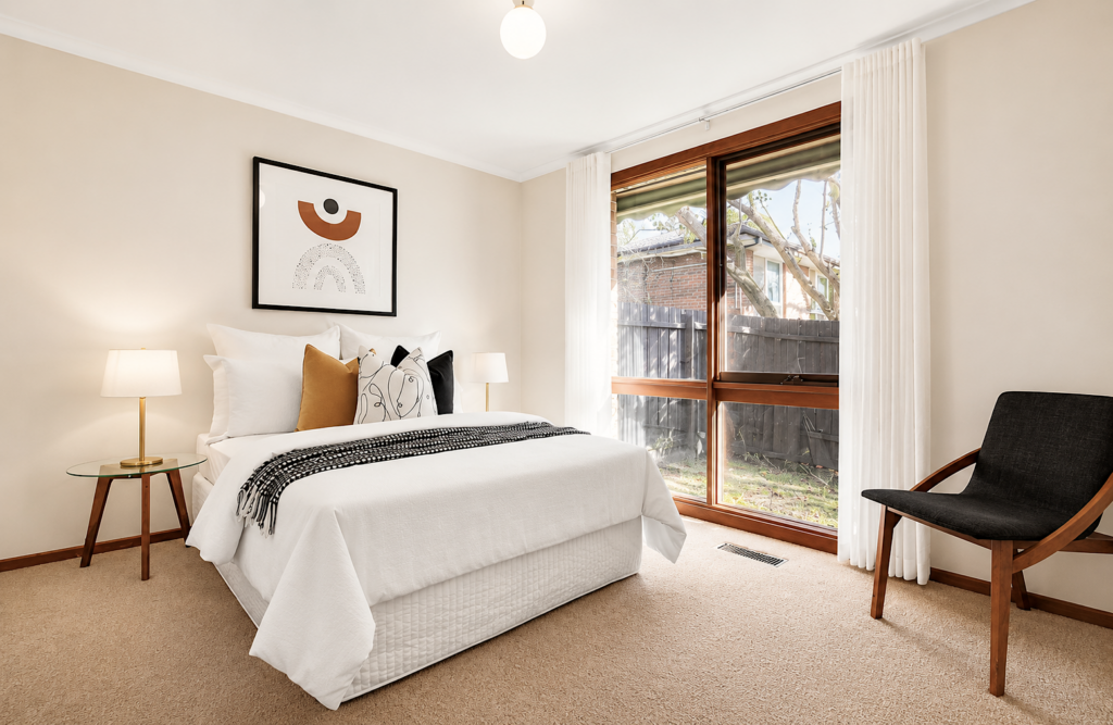 A standard bedroom in Mitcham staged with black white and mustard as the main colors