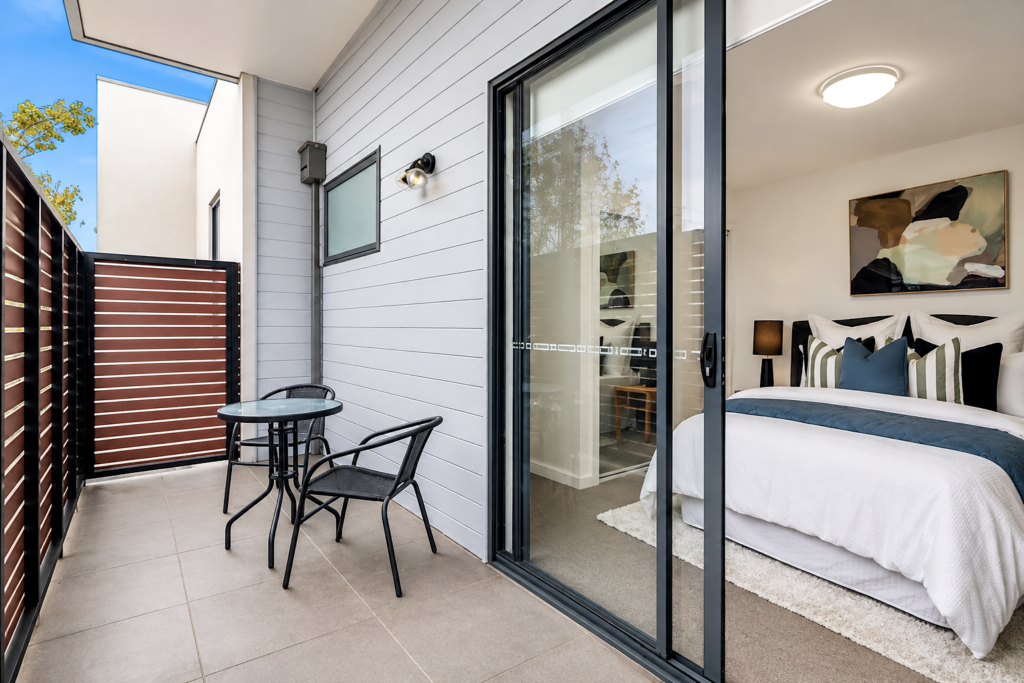 Private balcony connected to the master bedroom with outdoor seating in a townhouse in Carnegie.