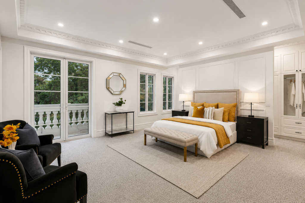 Luxury master bedroom with oversized proportions, upholstered bed, balcony access and elegant designer styling, premium house in Camberwell. Luxury master bedroom with oversized proportions, upholstered bed, balcony access and elegant designer styling, premium house in Camberwell.
