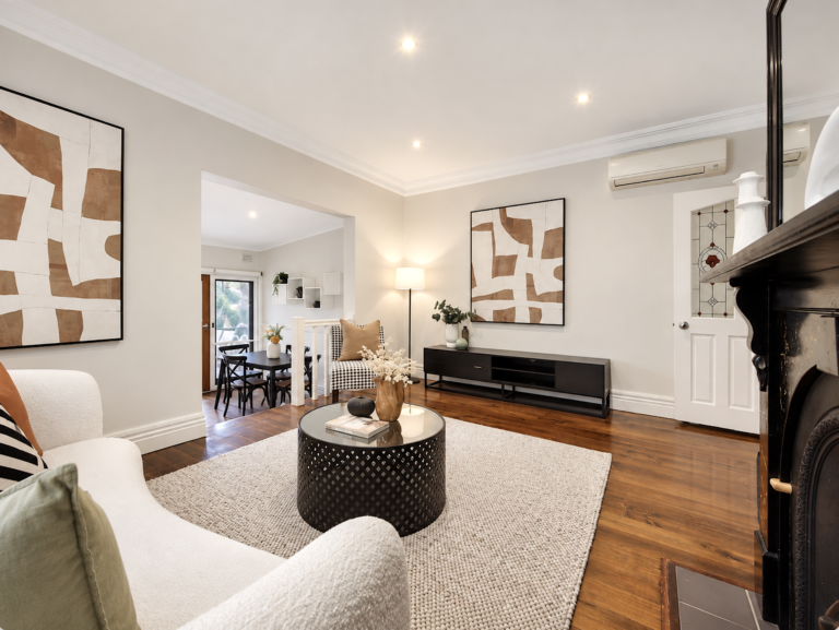 Modern property staging with neutral furniture, abstract artwork and warm timber flooring in Melbourne home