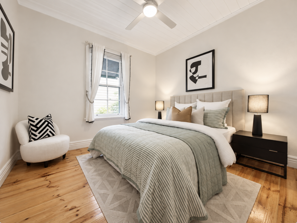 Staged bedroom with sage green bedding, modern black artwork and neutral furniture in Melbourne home
