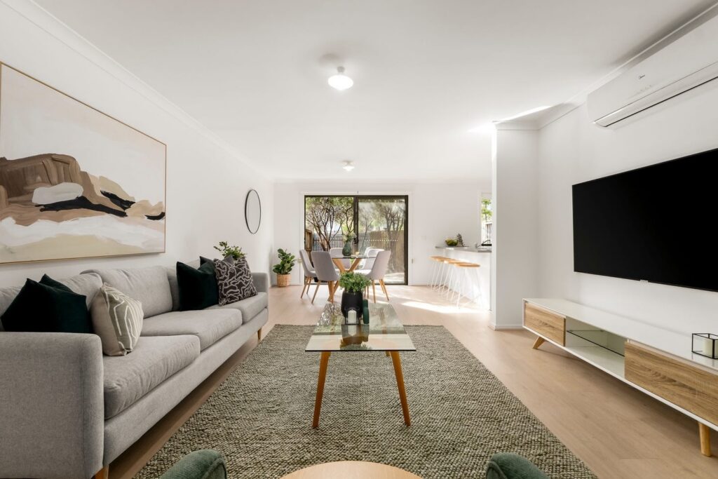 Staged open-plan living room with neutral furniture and dining area in a townhouse in Croydon