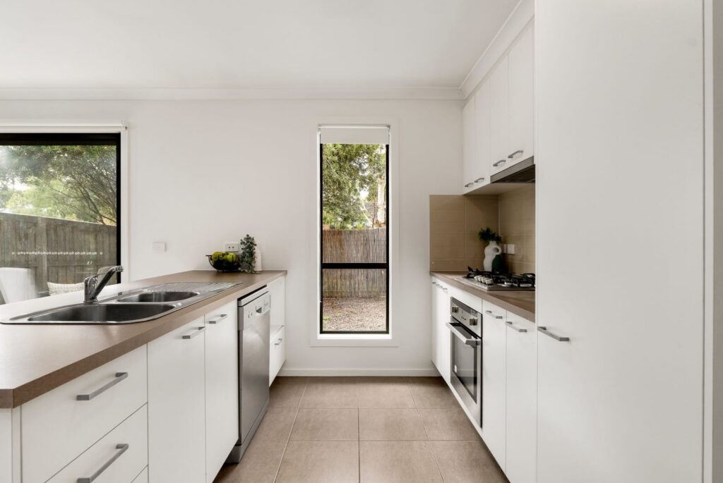 Bright modern kitchen with white cabinetry in a townhouse in Croydon