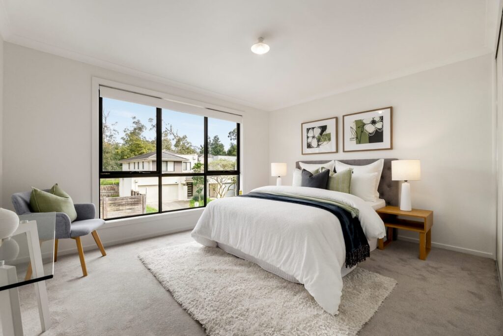 Staged master bedroom with green accents and neutral furnishings in a townhouse in Croydon